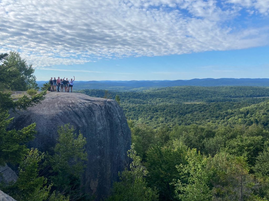 Leaders posed atop an Adirondack peak.