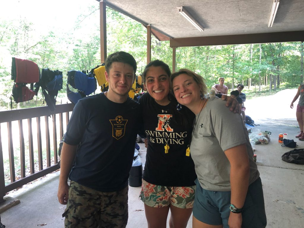 Leaders Lucy Voss, Gabe Dunbar, and Farah Ghazal caught smiling the camera. 