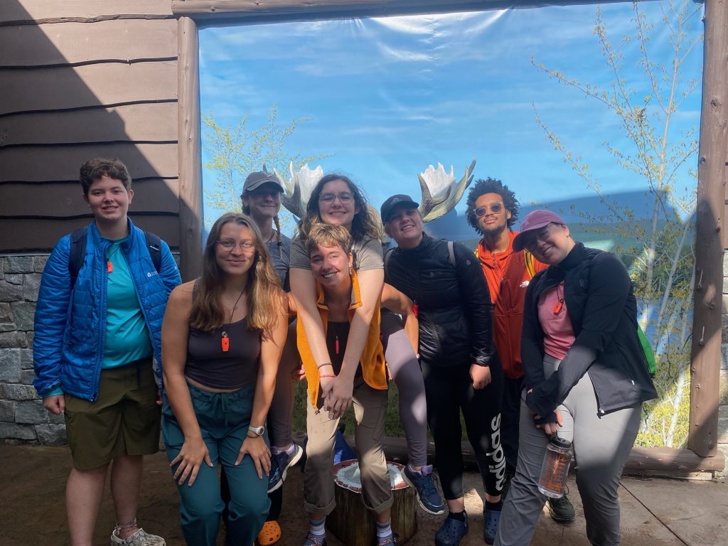 A basecamp patrol gets a photo infront of the moose antlers outside of the nature center. 