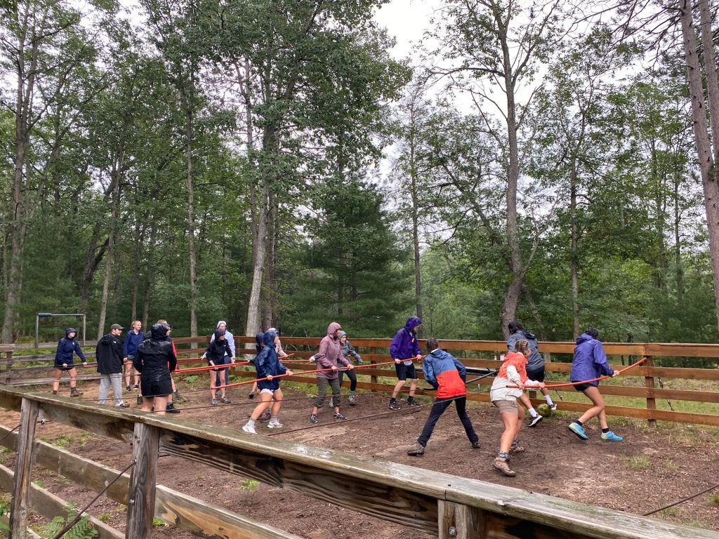 Participants and leaders engage in a game of human-foosball at Go-Rec facility. 