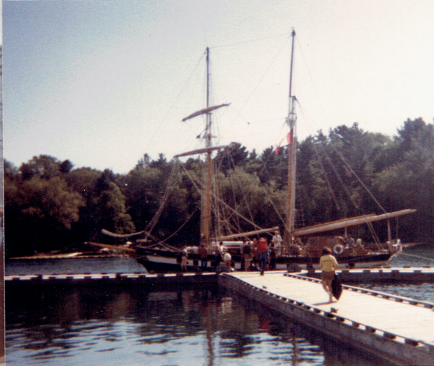 Photo of individuals approaching the sailboat, the playfair. 