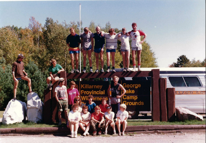 Group of participants and leaders pose by the sign for Killarney Provincial Wilderness. 