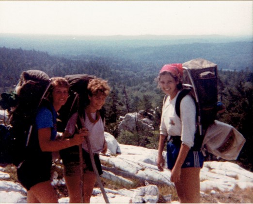 Group of three atop a summit. 