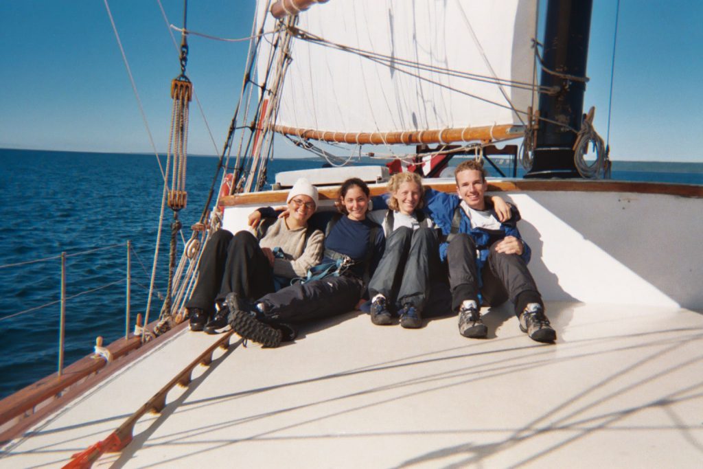 Four individuals sitting arm-in-arm on the Playfair.