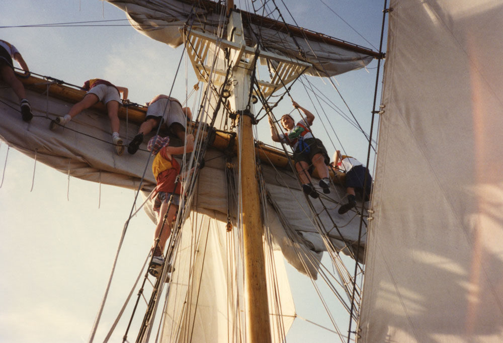 A group works on the sails.