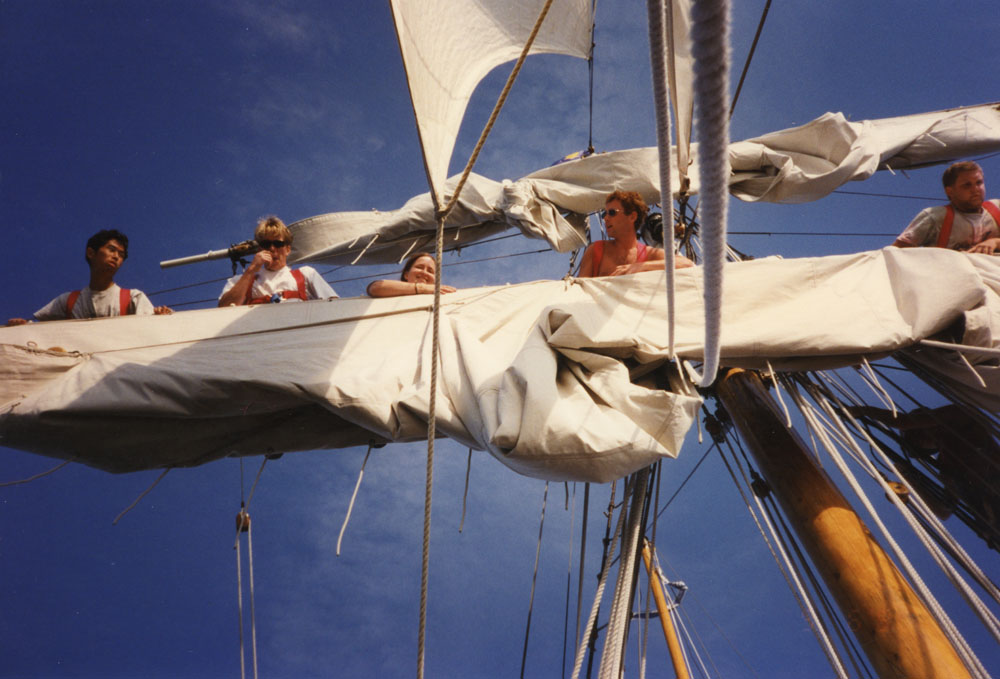 A group works on the sails.